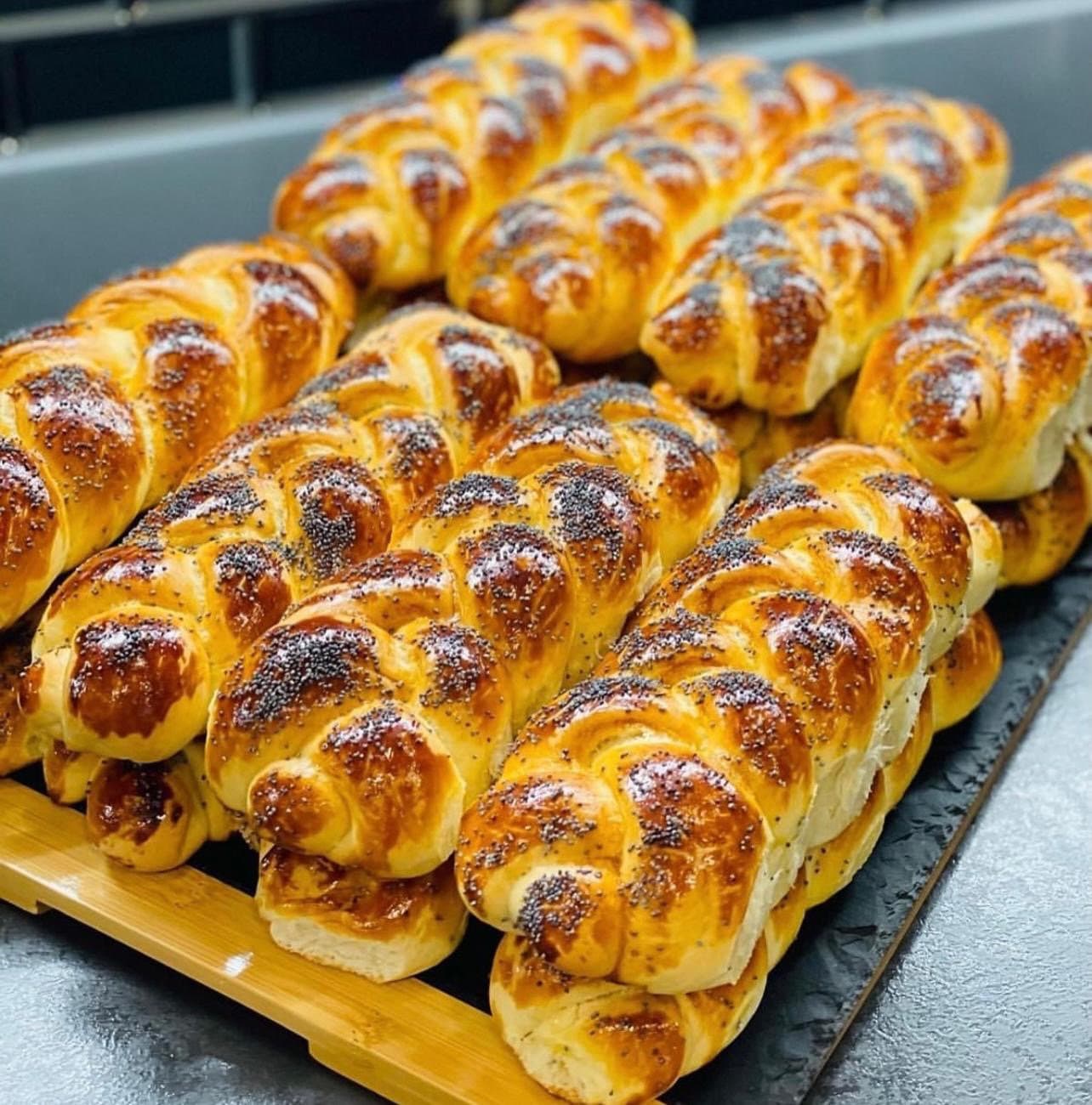 Braided cheese pastries on a wooden board